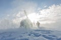 Heliski helicopter takes off in snow powder freeride landed on mountain Royalty Free Stock Photo