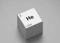 Helium element symbol, from periodic table on white cube on milimeter paper