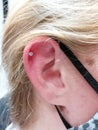 Helix Piercing with Titanium Prong Set Labret Royalty Free Stock Photo