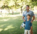 Hell always be a champ in my books. an adorable little boy playing soccer with his father in the park. Royalty Free Stock Photo