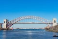 The Hell Gate Bridge over the East River with an Amtrak Acela Train