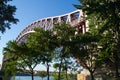 Hell Gate Bridge over the river and trees with blue sky at Astoria park