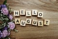 Hello August alphabet letters on wooden background