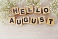 Hello august alphabet letters on wooden background