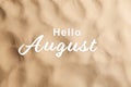 Hello August. Beach sand as background, top view