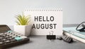 Hello August word in light box and flower