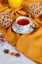 Hello Autumn background. Bright yellow wool sweater, cup of tea, honey, vine balls, anise stars, sea buckthorn berries