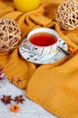 Hello Autumn background. Bright yellow wool sweater, cup of tea, honey, vine balls, anise stars, sea buckthorn berries