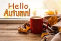 Hello Autumn card. Cup of hot drink, golden leaves and scarf on windowsill Royalty Free Stock Photo