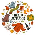 Hello autumn circle composition. Autumn essentials warm clothes, berries and leaves, book, all for warm atmosphere. Fall