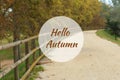 Hello Autumn greeting card with deserted gravel road in background Royalty Free Stock Photo