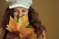 Happy trendy woman in sweater on bronze background Royalty Free Stock Photo