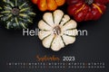 The Hello Autumn on September 2023 calendar and pumpkins on black cardboard background Royalty Free Stock Photo