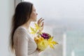 Hello autumn. Young smiling woman with autumn bouquet of yellow and orange flowers, purple ornamental cabbage and maple leaves. Fe Royalty Free Stock Photo