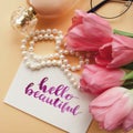 Hello beautiful handwritten with watercolor in calligraphy style. Women`s fashion accessories arrangement on a pale peach pastel