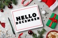 Hello December greeting card. Flat lay composition with Christmas decor on grey background Royalty Free Stock Photo