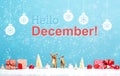 Hello December message with reindeer and Christmas gifts Royalty Free Stock Photo