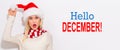 Hello December message with woman with Santa hat Royalty Free Stock Photo