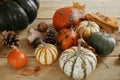 Hello Fall! Pumpkins, autumn leaves, nuts and cone on rustic wooden table in farmhouse. Cozy autumn home decor. Happy Thanksgiving Royalty Free Stock Photo