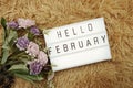 Hello February word in light box and flower bouquet Royalty Free Stock Photo