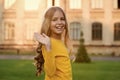 Hello gorgeous. Happy child wave hand outdoors. Little child smile in casual style. Small child wear long wavy hair