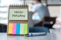 Hello Holiday text on note paper or empty reminder template on wooden table. New Goal New Start concept Royalty Free Stock Photo