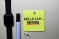Hello I am Newbie text on sticky notes isolated on office desk