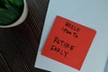 Hello I Plan to Retire Early write on sticky notes isolated on Wooden Table