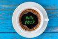 Hello 2017 inscription on top view morning cup of coffee. Happy New Year and Christmas concept