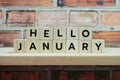 Hello January alphabet letter on shelves wooden background