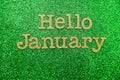 Hello January alphabet letters on green glitter background Royalty Free Stock Photo