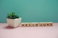 Hello June alphabet letter on blue and pink background