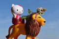 Hello Kitty figure by Mega Bloks, riding on LEGO Duplo male lion, holding cat attractive herb Catnip