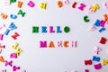 Hello March. Scattered colorful wooden letters