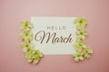 Hello March card typography text with flower bouquet on pink background