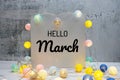 Hello March text message with LED cotton ball decoration on wooden background Royalty Free Stock Photo