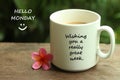 Hello Monday greetings with a smile face emoticon - Wishing you a really great week.  With white mug of coffee and notes on it. Royalty Free Stock Photo