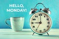 Hello, Monday Inspirational greeting card with a vintage alarm clock