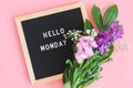 Hello Monday text on black letter board and bouquet colorful flowers on pink background. Concept Happy Monday. Template for Royalty Free Stock Photo