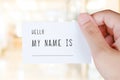 Hello my name is words on name card in hand background Royalty Free Stock Photo