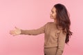 Hello, nice to meet! Side view of friendly kind young woman with brunette hair giving hand to handshake, greeting