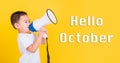 Hello October, Asian Thai happy cute little cheerful child boy holding and shouting or screaming through the megaphone Royalty Free Stock Photo