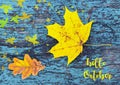 Hello October.Colorful autumn background with autumn leaves on blue colored old wooden texture.Yellow maple and oak tree leaf.Fall