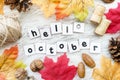 Hello October greeting card , autumn background with dry fall leaves