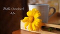 Hello October. October greeting concept with a smile and a cup of coffee and sun flower. Welcoming new month of October.