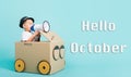 Hello October, Happy Asian children boy smile in driving play car creative by a cardboard box imagination with megaphone