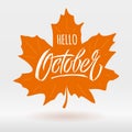 Hello October lettering with maple leaf on light background. Modern brush calligraphy. Autumn banner. Vector typography