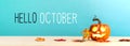 Hello October message with pumpkin on a table Royalty Free Stock Photo