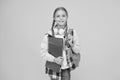 Hello school. Happy girl ready for school on yellow background. Little kid hold books and school bag. Small child back Royalty Free Stock Photo