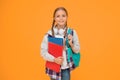 Hello school. Happy girl ready for school on yellow background. Little kid hold books and school bag. Small child back Royalty Free Stock Photo